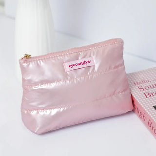 EyeCandys pink puffy essentials pouch for makeup, glasses, and contact lens storage.