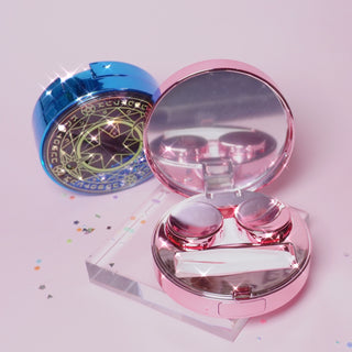 Sailor Moon themed contact lens case in blue and pink. The Pink one is open and shows a compartment for putting in a pair of contact lenses and a rubber ended tweezer tool for handling the contact lens.