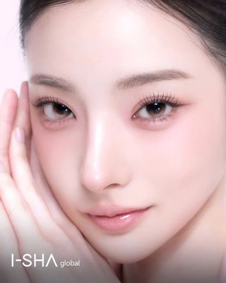 Closeup beauty portrait of a woman wearing gray brown contact lenses, with a clean makeup, and a non-rotating lens design overly with 1-month Reborn branding.
