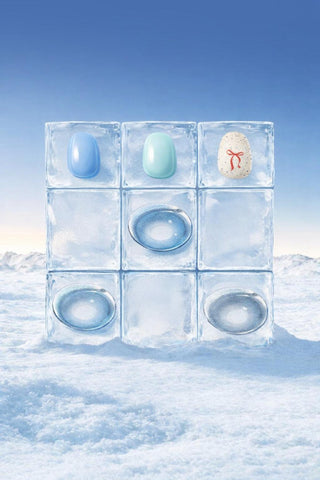 Creative flat lay of Eyecandys blue and grey prescription contact lenses with gel nail stickers on ice cubes, showcasing product colors and styling.