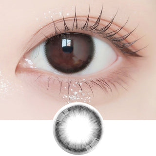 Close-up shot of model's eye adorned with Ann365 JUST 1-Day Black (10pk) daily color contact lenses with prescription, paired with clean-girl eye makeup, showing the brightening and enlarging effect of the circle contact lens on dark brown eyes, above a cutout of the contact lens with limbal ring on a white background.