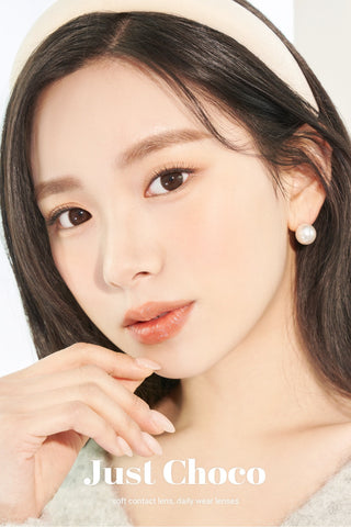 A close-up of a model demonstrating a natural makeup look with Ann365 JUST Choco (Toric for Astigmatism) (1 PAIR) circle colour contacts, highlighting how well the contact lenses blend with her dark eyes.
