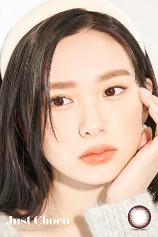 A close-up of a model demonstrating a natural makeup look with Ann365 JUST 1-Day Choco (10pk) circle colour contacts, highlighting how well the contact lenses blend with her dark eyes.