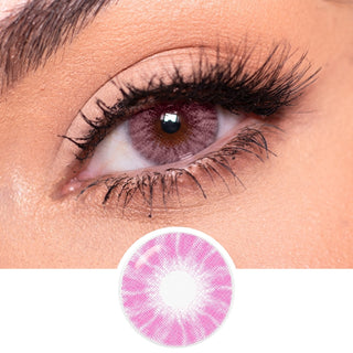 A close-up highlights EyeCandys Shade Pink colored contacts for dark eyes, set against long, dark lashes and defined brows. Below the eye is a separate image of the EyeCandys contact lens in pink.