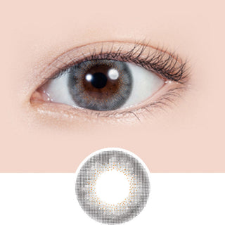 Close-up shot of model's eye adorned with Lilmoon Monthly Rusty Grey (Non Prescription) color contact lenses prescription, paired with clean-girl eye makeup, showing the brightening and enlarging effect of the circle contact lens on dark brown eyes, above a cutout of the contact lens with limbal ring on a white background.