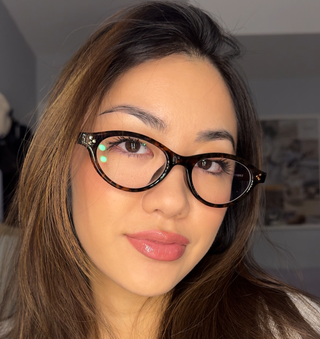 Model wearing EyeCandys Loretta oval full-frame prescription glasses in Milk Tea, lightweight TR material, medium fit, flattering for diamond and heart-shaped faces