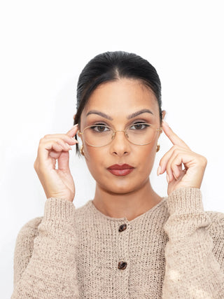 Marina wearing EyeCandys Zephyr Slim Oval prescription glasses – lightweight oval eyeglass frames with blue light blocking lenses, Zeiss HMC anti-glare coating, photochromic UV-responsive transitions, and polarized sunglasses option. Minimalist oval glasses for digital eye strain and everyday wear.