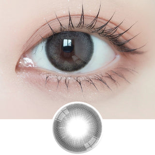 Close-up shot of model's eye adorned with Ann365 Mauve Deep Grey daily color contact lenses with prescription, paired with clean-girl eye makeup, showing the brightening and enlarging effect of the circle contact lens on dark brown eyes, above a cutout of the contact lens with limbal ring on a white background.