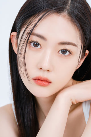 A close-up of a model demonstrating a natural makeup look with Ann365 Mauve Deep Grey circle colour contacts, highlighting how well the contact lenses blend with her dark eyes.