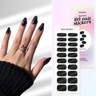 Hand with EyeCandys Meow Me Back Gel nail stickers applied, featuring a sleek black color with glitter accents. Perfect for edgy, glamorous manicures, offering long-lasting wear, easy application, and a sparkling, salon-quality gel finish for eye-catching nails.