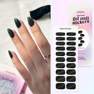 Hand with EyeCandys Meow Me Back Gel nail stickers applied, featuring a sleek black color with glitter accents. Perfect for edgy, glamorous manicures, offering long-lasting wear, easy application, and a sparkling, salon-quality gel finish for eye-catching nails.
