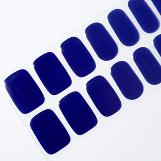 Angled image of semi-cured gel nail stickers in the design 'Midnight Magic,' showcasing a rich, deep navy blue color for an elegant and timeless look.