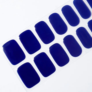 Angled image of semi-cured gel nail stickers in the design 'Midnight Magic,' showcasing a rich, deep navy blue color for an elegant and timeless look.