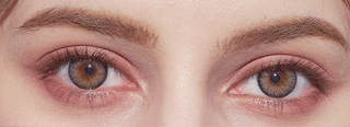 Close-up of eyes with brown irises enhanced by NEO Vision Cosmo Grey lenses from NEO Vision, featuring long lashes, well-groomed brows, soft pinkish-brown eyeshadow on the lids, and fair, smooth skin.