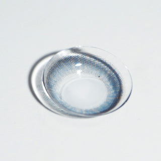 Macro shot of EyeCandys NEO Monet Blue toric lens – detailed design of prescription colored contact lenses for astigmatism, vibrant blue color contact lenses.