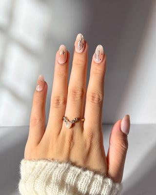 Hand featuring Eyecandys Papillon Gel Nail Stickers, designed for quick 10-minute application, lasting 2-3 weeks, and strengthening nails with a 7-free, odor-free formula