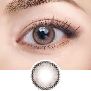 Close-up of eye with long lashes wearing EyeCandys NEOism Milk Brown prescription colored contact lens - detailed pixelated lens design shown below, warm natural brown color, comfortable daily wear, trending cosmetic lenses