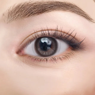 Close-up of eye with long lashes wearing EyeCandys NEOism Pure Mud Black prescription colored contact lens - deep natural black color, detailed lens design, comfortable daily wear, trending cosmetic lenses