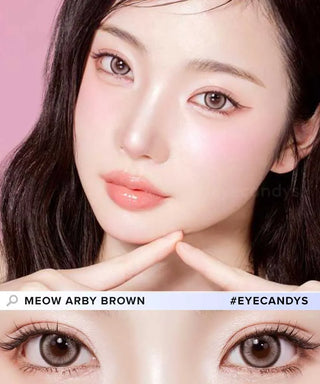 A female model with natural dark eyes wearing Olala Meow Aby Brown contact lenses, complemented by subtle eyeshadow and peach lip gloss and Close-up image showcases the model's eyes adorned with the same Brown contact lenses