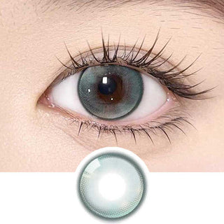 Olala Meow Havana Green color contact lens on top of a dark eye paired with subtle eye makeup and curled wispy eyelashes, above the contact lens design.