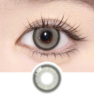 Olala Meow Rubl Green color contact lens on top of a dark eye paired with subtle eye makeup and curled wispy eyelashes, above the contact lens design.