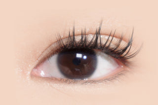 Close-up of model's natural brown eyes with long lashes — showcasing the beauty of unenhanced eye color and natural lash length, perfect for highlighting the elegance of natural eye features