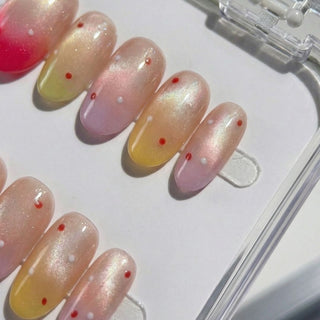 Sorbet Season press on nails by EyeCandys featuring hot pink to amber to mauve to lilac gradient with scattered white and red confetti dots.