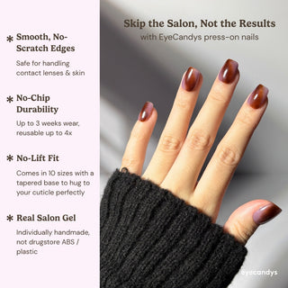 Hand wearing EyeCandys Night Plum press on nails with dark polished marbled plum design.