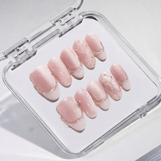Close-up of EyeCandys Ballet Slippers press on nails in soft nude pink with glossy satin finish, quilted detailing, pearl outlines, and subtle French tip design on a white background.