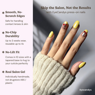 Hand wearing EyeCandys Cherry Picnic press on nails featuring playful cherry accents and glossy pastel yellow design.
