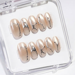 Close-up of EyeCandys In the Lines press on nails on a white background featuring soft white cat-eye base with pearly glow, silver vein details, and small gem accents.