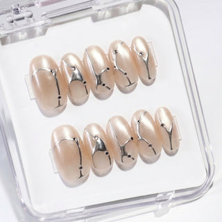 Close-up of EyeCandys In the Lines press on nails on a white background featuring soft white cat-eye base with pearly glow, silver vein details, and small gem accents.