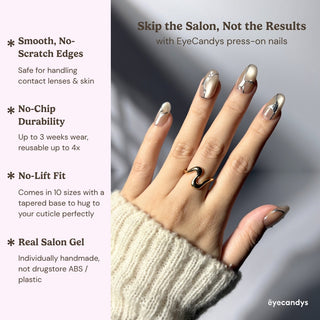 Hand wearing EyeCandys In the Lines press on nails with soft pearly white finish, thin silver vein design, and subtle gems.