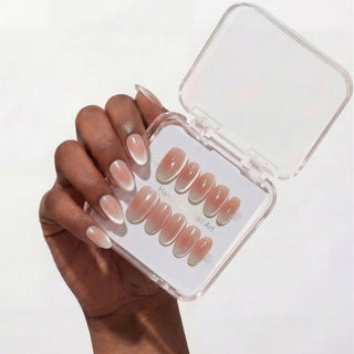 Hand featuring EyeCandys Cloud Nine press on nails with clean milky white gradient and subtle celestial cat-eye glow.