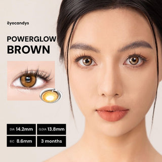 Model showcasing EyeCandys PowerGlow Brown lens with natural glowing makeup, enhancing eyes with soft brown tones.