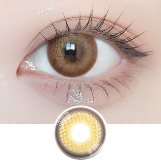 Close-up shot of model's eye adorned with Ann365 Photogenic 1-Day Creme Beige (10pk) daily color contact lenses with prescription, paired with clean-girl eye makeup, showing the brightening and enlarging effect of the circle contact lens on dark brown eyes, above a cutout of the contact lens with limbal ring on a white background.