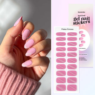 Hand displaying EyeCandys Pilates Princess Gel Nail Stickers in pink with glitter accents. Effortless spring nails with a 7-free, allergy-friendly formula that lasts 2-3 weeks. Cures in sunlight without a UV lamp, adding a touch of sparkle for trendy, long-lasting nail looks.