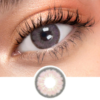 Close up shot of a model with natural dark eyes wearing EyeCandys Pink Label Angel Pink colored contact lens complemented by natural eye make up