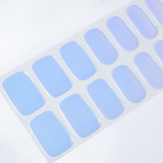 Angled image of semi-cured gel nail stickers in the design 'Pink Soda Pop,' featuring a soft pastel pink and blue gradient with a glossy finish for a charming and vibrant look.