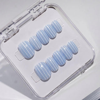 EyeCandys Pinstripes press on nails featuring glossy periwinkle blue nails with crisp white vertical pinstripe design in short round shape.