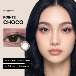 A woman with long black hair wears EyeCandys Pink Label Pointe Choco contact lenses. Text displays lens details: DIA 14.0mm, G.DIA 13.2mm, B.C 8.6mm, and a usage period of 3 months.