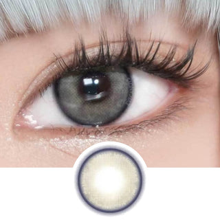 Model's eye with long lashes wearing EyeCandys Powerglow Grey colored contact lenses. Below is a graphic design of the grey contact lens, perfect for cosplay and prescription colored contact lenses