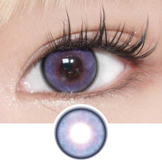 Eye of a model with long lashes wearing EyeCandys Powerglow Purple colored contact lenses. Below is a graphic design of the purple lens, offering a bold look for cosplay and available in prescription options