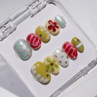 EyeCandys Pucker Up Press-On Nails come in a clear case with vibrant red, yellow, white, and green designs—flowers, stars, wavy patterns, polka dots, and glitter—for an easy-to-apply, reusable salon gel manicure look.