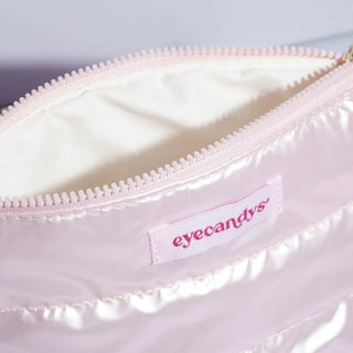 EyeCandys Puffy Essentials Pouch in pearlescent pink with quilted design and branded tag — perfect for storing makeup, contact lens kits, or glasses; stylish, wipeable, and travel-friendly.