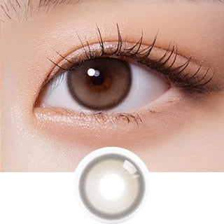 Close-up of an eye wearing Olola Purity Shine 1-Day Taupe Brown contacts by Olola, revealing detailed lashes and smooth skin. Below is a daily disposable myopia lens from the 10-pack, shown on a white background.