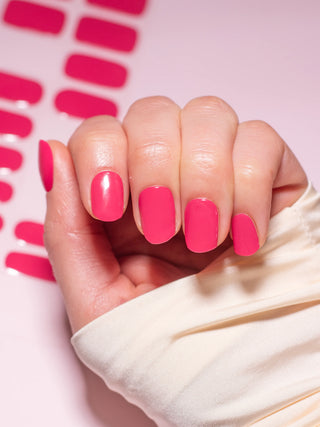 Hand with EyeCandys Red My Mink Gel nail stickers applied, showcasing a bold red color. Ideal for classic, vibrant manicures, offering long-lasting wear, easy application, and a high-shine, salon-quality gel finish for stunning, polished nails.