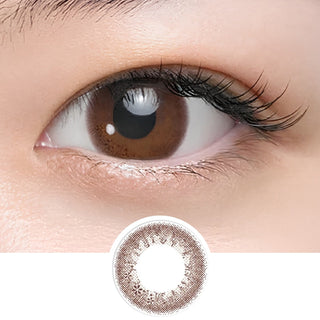 Close-up of eye wearing EyeCandys Seed Coffret Sweetie Make Brown (10pk) prescription colored contact lens with lens design shown below, warm brown two-tone gradient with pink undertone and delicate floral pattern, glossy Korean daily disposable colored contacts for doe eyes