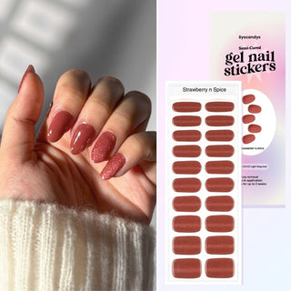 Hand displaying EyeCandys Strawberry Spice Gel Nail Stickers in a vibrant strawberry color with glitter. Trendy spring nails with a 7-free, allergy-friendly formula that lasts 2-3 weeks. Cures in sunlight, no UV lamp required, for a sparkling, sweet nail look