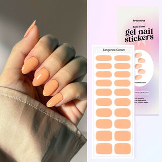 Hand displaying EyeCandys Tangerine Cream Gel Nail Stickers in a delicate pastel orange. Elegant spring nails with a 7-free, allergy-friendly formula that lasts 2-3 weeks. Cures in sunlight in just 5-10 minutes for a fresh, effortless nail design.